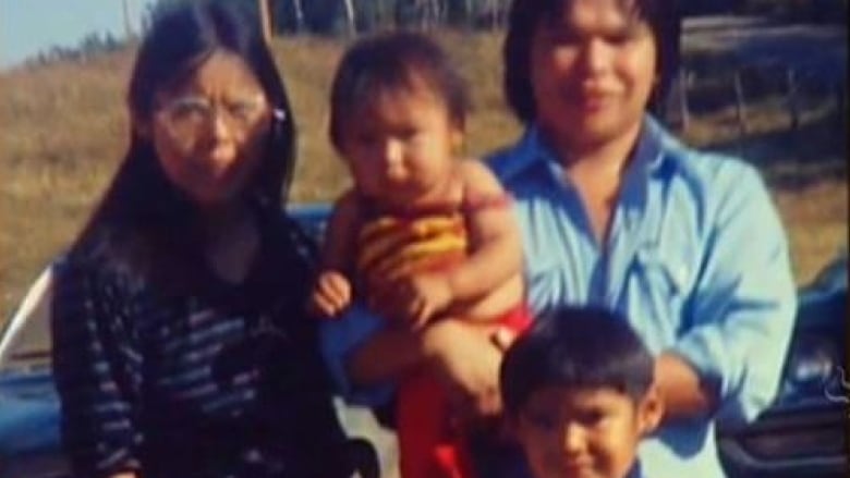 A family poses in a photo.