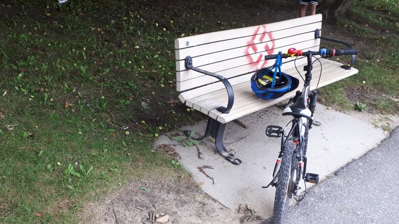 A park bench with a swastika.