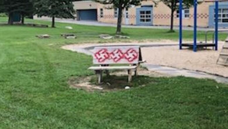 A park bench with swastikas.