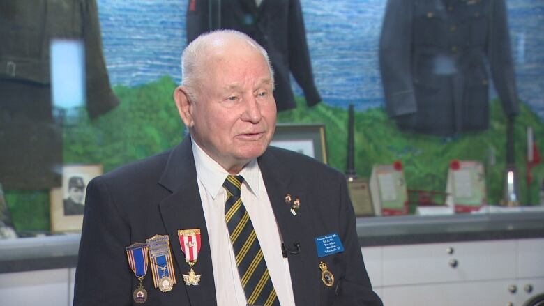 Don Asher, a blading man, shown wearing his medals.