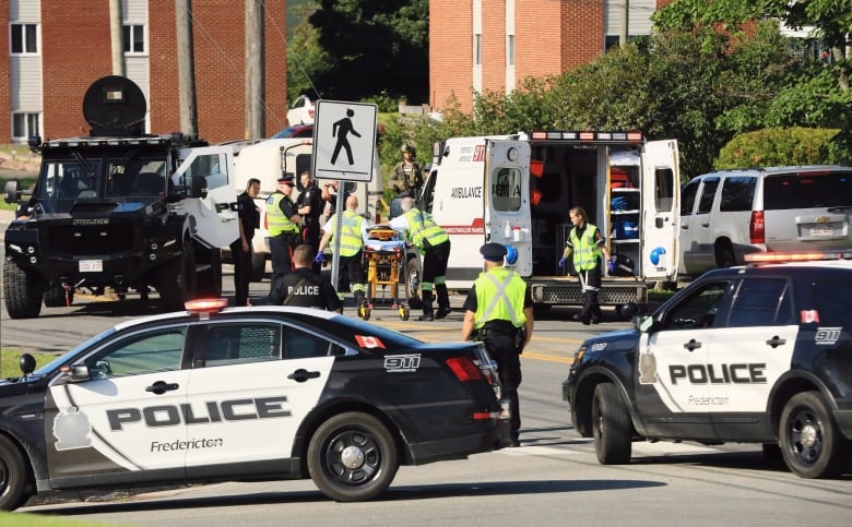 Police cars, ambulances, and officers at the scene of the shooting in 2018