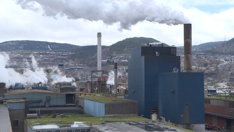 Factory with smoke coming out of it's pipes