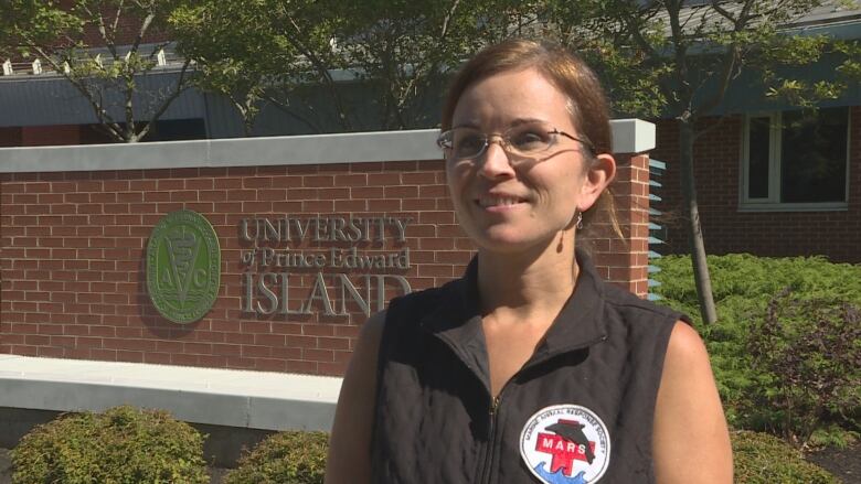 A woman with a MARS shirt speaks to the camera.