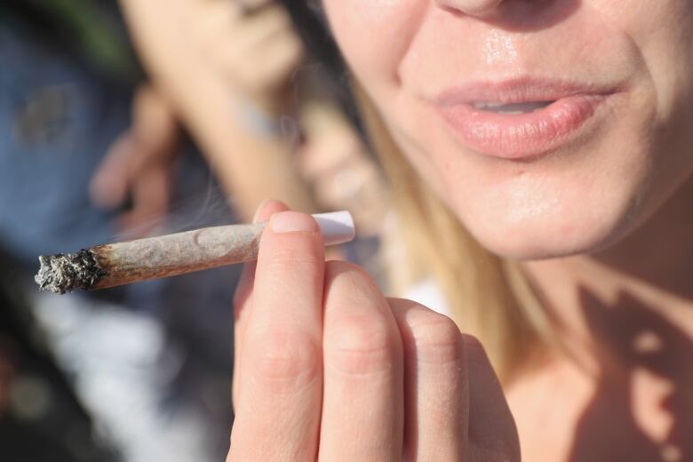 A woman smoking a joint 