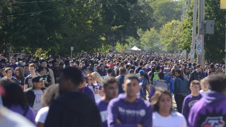 A sea of purple engulfs Broughdale Avenue, a street full of mostly student rental homes near the eastern gates of the Western University that is now ground zero for so-called fake Homecoming celebrations.