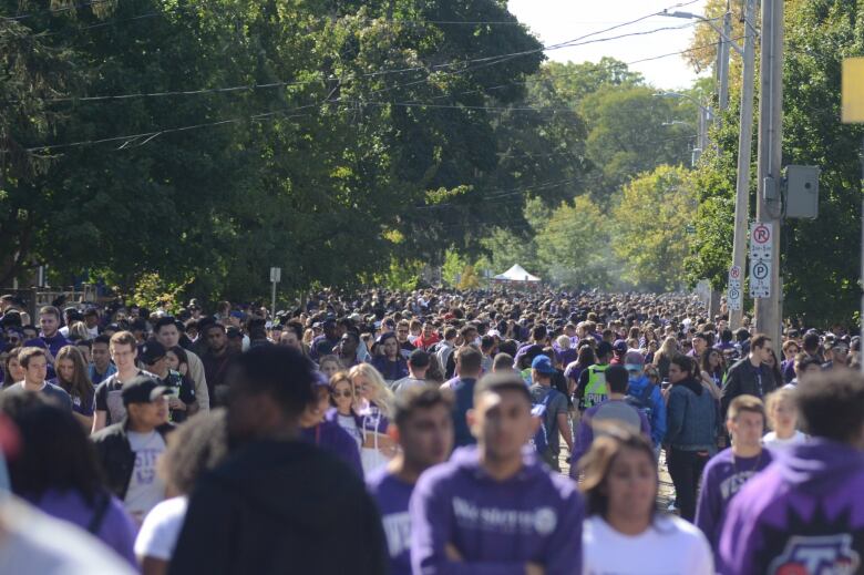 A sea of purple engulfs Broughdale Avenue, a street full of mostly student rental homes near the eastern gates of the Western University that is now ground zero for so-called fake Homecoming celebrations.