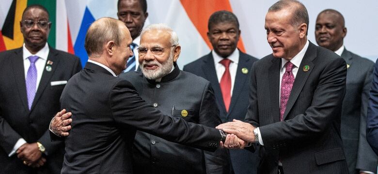 Russian President Vladimir Putin, Indian Prime Minister Narendra Modi and Turkish President Tayyip Erdogan interact before a group picture at the BRICS summit meeting in Johannesburg, South Africa, July 27, 2018.