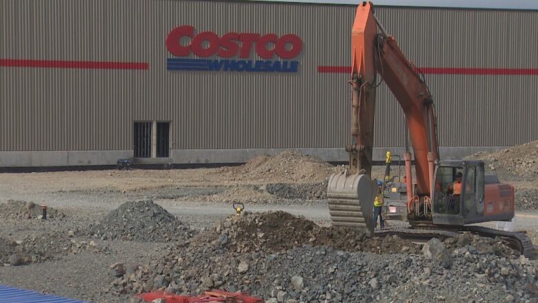 Digging machinery in front of costco building