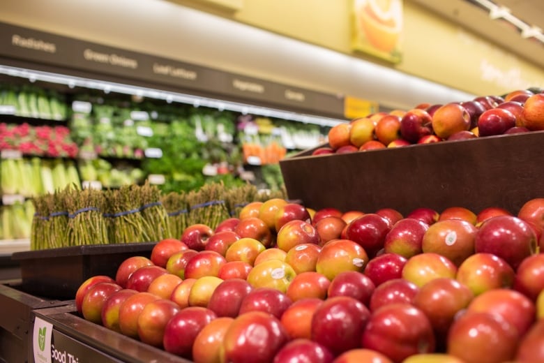 A row of apples in a grocery store.