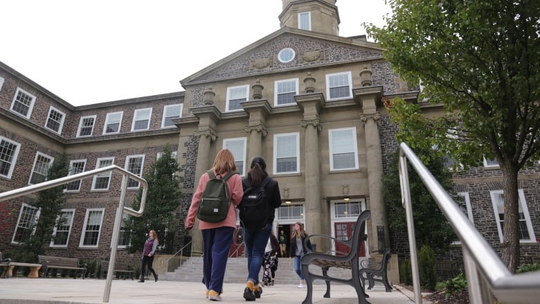 Two students walk towards the Henry Hicks Academic Administration Building at Dalhousie University.