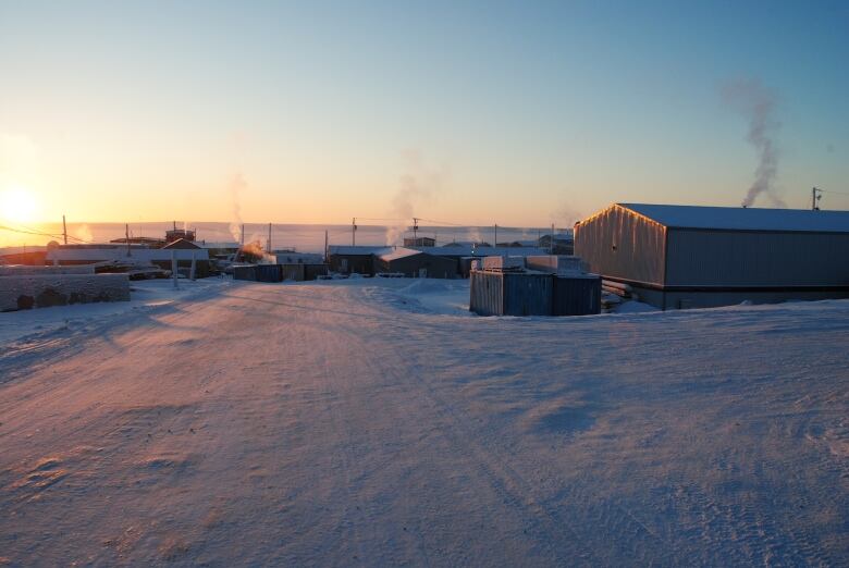 Steam rising from boxy houses in winter light.