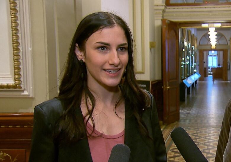 Young woman in hallway of a legislature building.