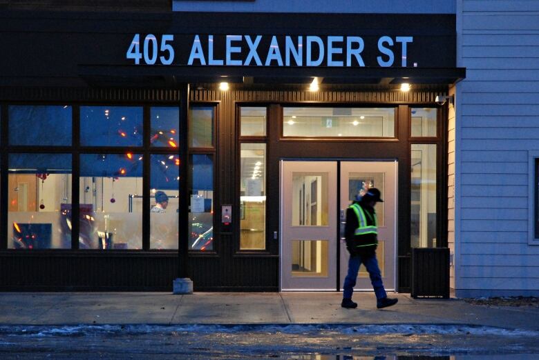 A person walks in front of the doors of a Whitehorse shelter. 