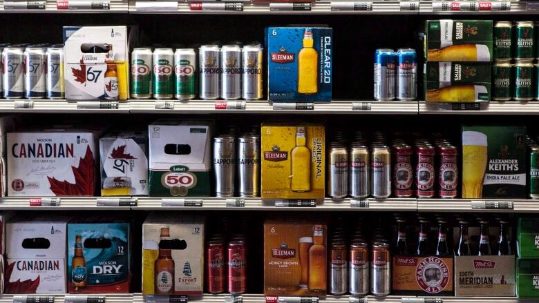  A range of beer products on shelves at a Beer Store outlet, including Guinness, Sapporo, Molson Canadian and Sleeman. 