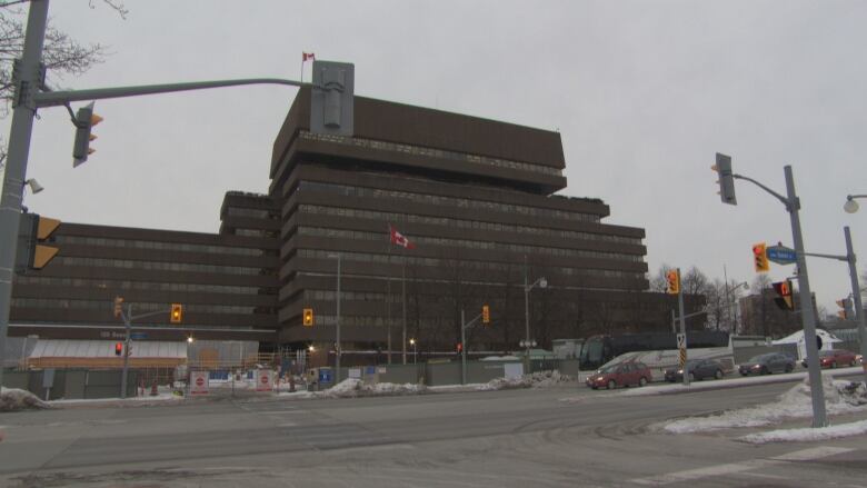 A multi-storey building with windows is pictured from the outside.