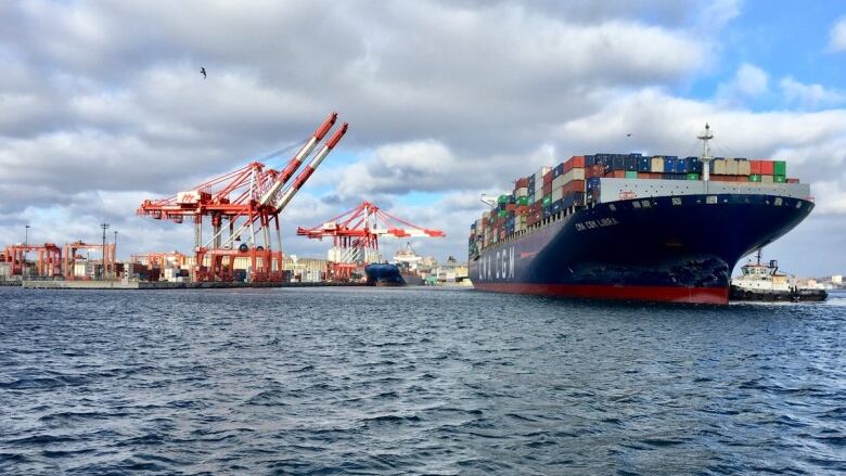 A large container ship is seen next to the Port of Halifax.