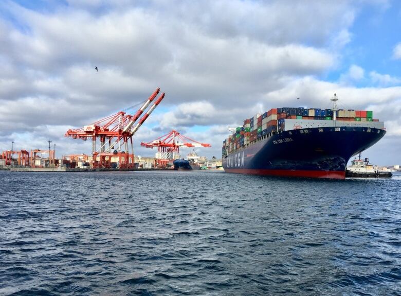 A large container ship is seen next to the Port of Halifax.