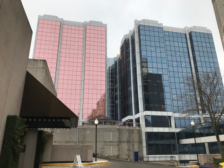 Two large office buildings with glass windows. 