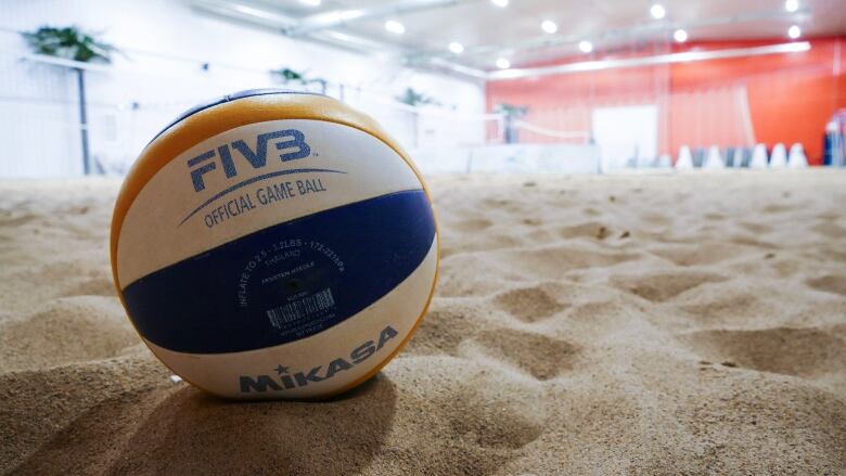 A beach volleyball in sand.