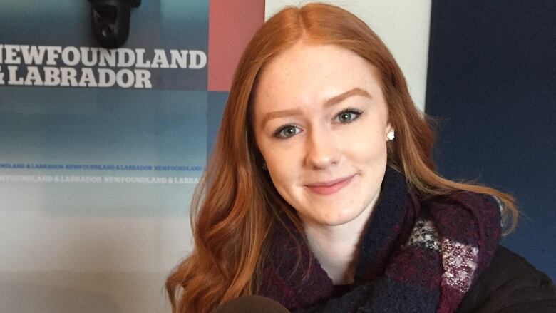 A headshot of singer/song writer Rachel Cousins, with a logo for CBC Newfoundland and Labrador in the background. 