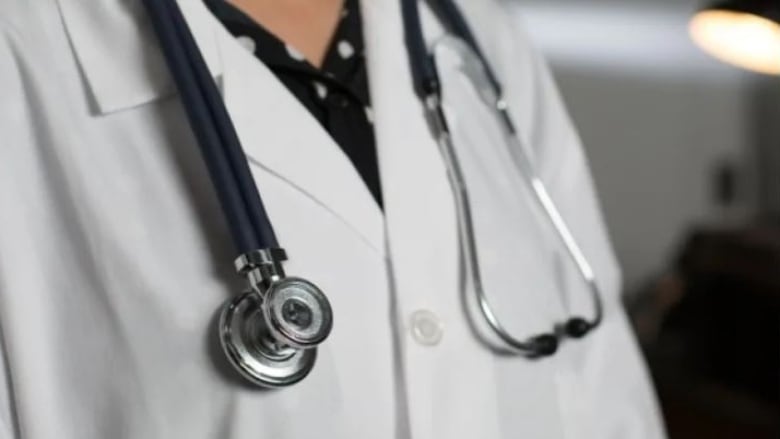 Photo of a doctor wearing a lab coat and stethoscope 