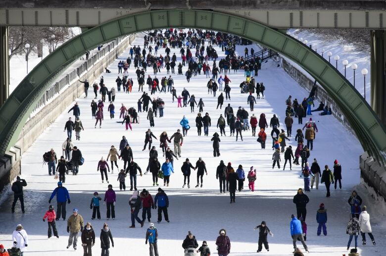 People skate on a city's frozen canal.