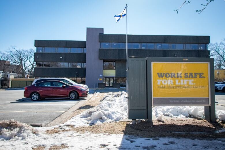 The Nova Scotia Workers' Compensation Board building with a sign out front showing the motto 'Work Safe. For Life.'