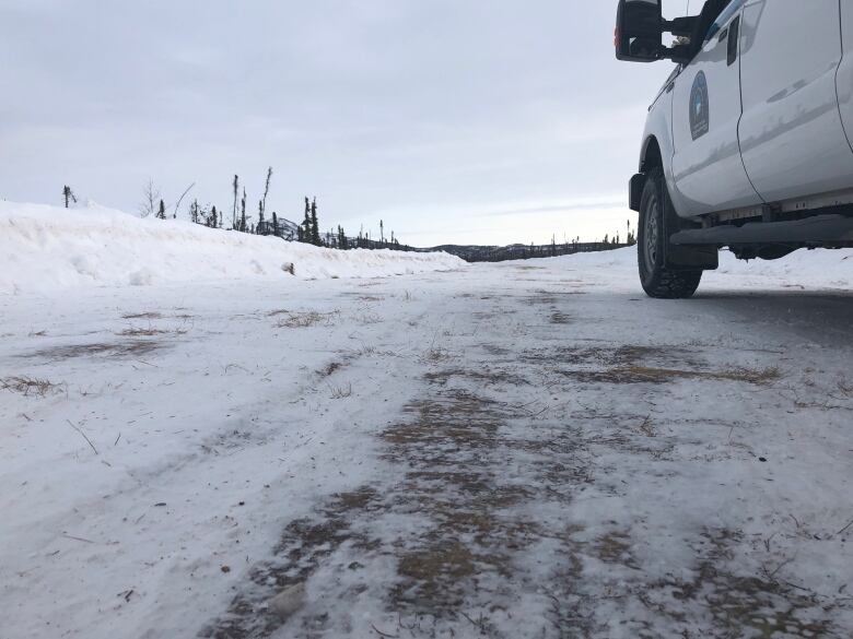 A vehicle is seen stopped on a snow-covered road.