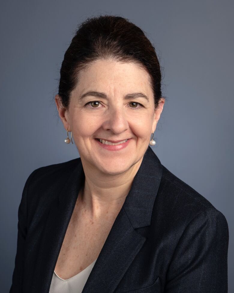 A woman smiles in a headshot.