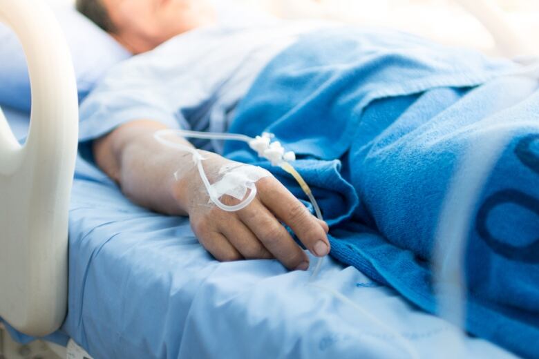 Person lying down in hospital bed