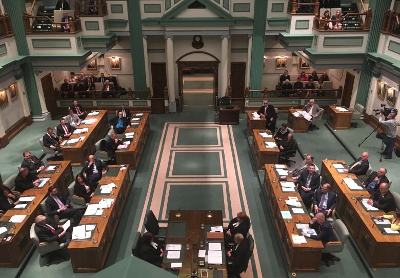 Members sit at their desks in the House of Assembly.