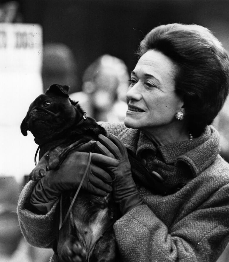 Woman holding pug dog