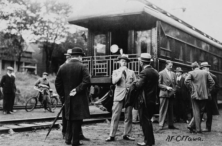 Men standing outside a train