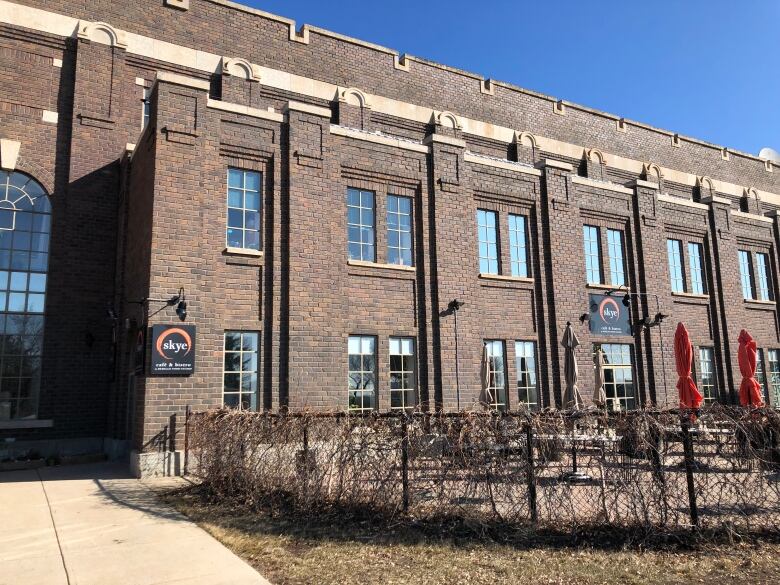 A large brick buildings with tall windows.