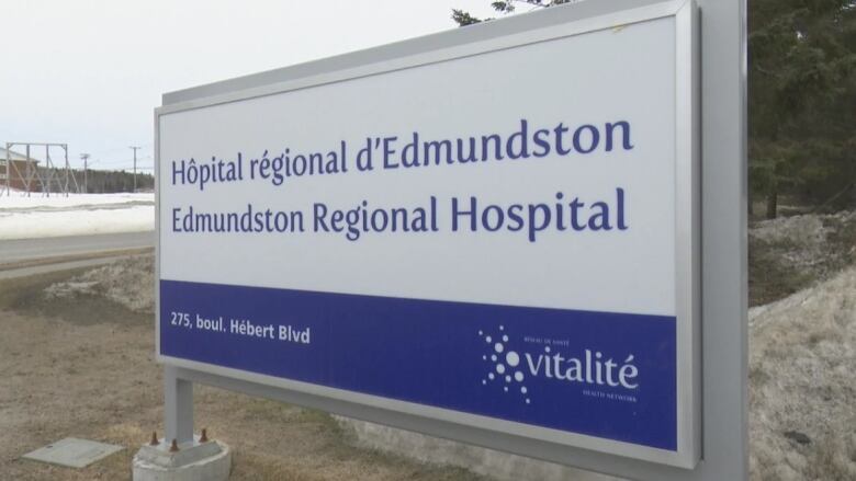 A large blue and white bilingual sign bearing the name of the Edmundston Regional Hospital and its address, as well as Vitalit.