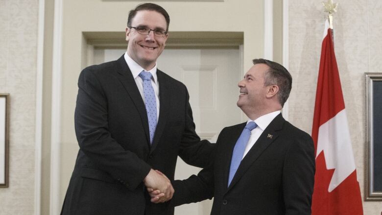 Alberta Premier Jason Kenney shakes hands with Jason Nixon, his much taller Minister of Environment and Parks, after being sworn into office last week. 