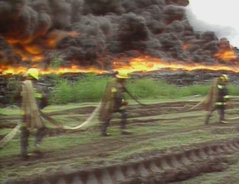 Firefighters at scene of a tire fire