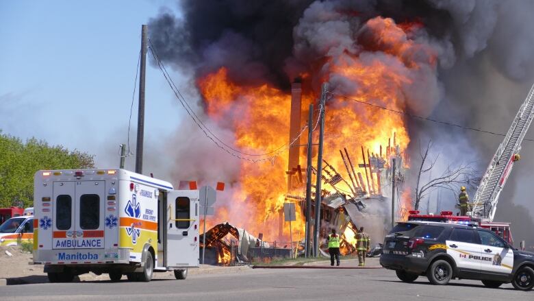 Flames shoot out of a building.