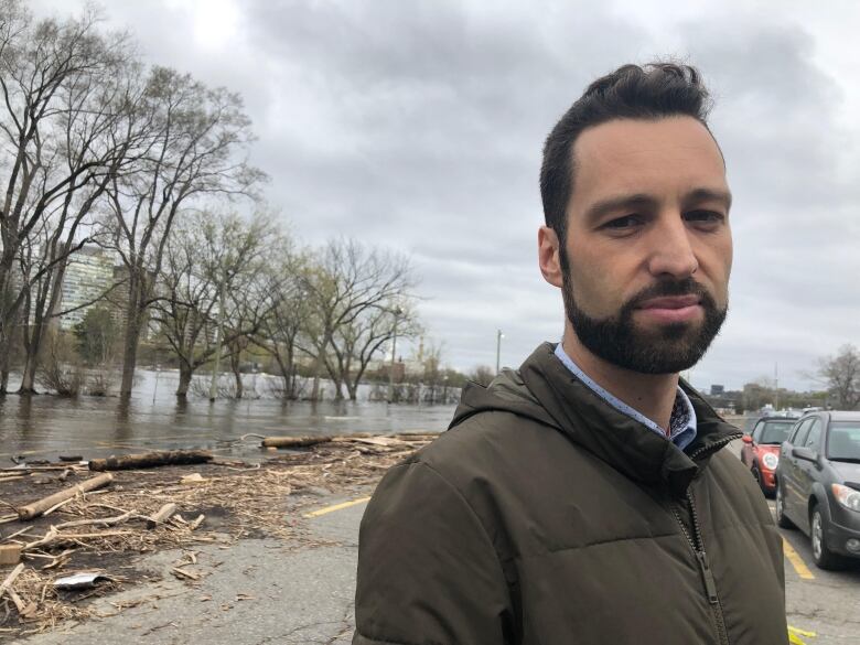 A man standing in front of a flooded area.