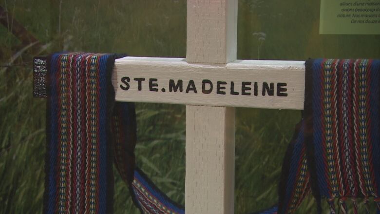 A small wooden cross with the words Ste. Madeleine written on it