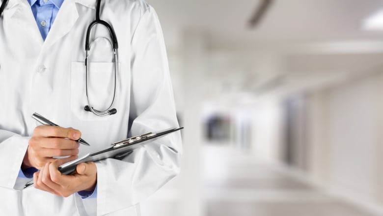 A stock image of a doctor holding a clipboard.