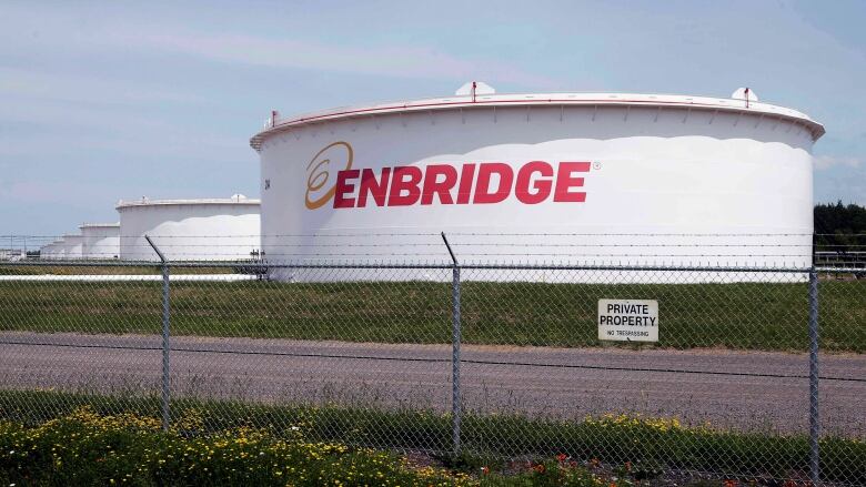 FILE - This June 29, 2018 photo shows tanks at the Enbridge Energy terminal in Superior, Wis. Enbridge Energy's plan to replace its aging Line 3 crude oil pipeline across northern Minnesota has hit another obstacle. Earlier this month a court said the project's environmental impact statement failed to address the possibility of an oil spill into the Lake Superior watershed. Now the Minnesota Pollution Control Agency and Department of Natural Resources say they can't take final action on the project's permits until the Public Utilities Commission addresses the deficiencies. (AP Photo/Jim Mone, File)