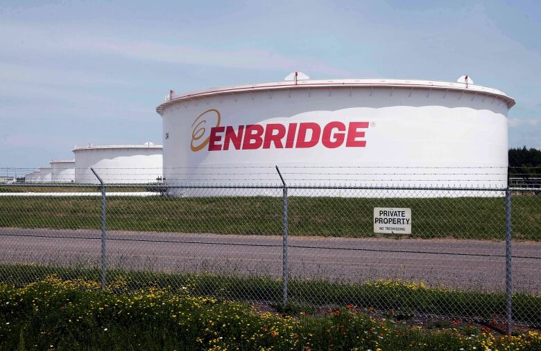 FILE - This June 29, 2018 photo shows tanks at the Enbridge Energy terminal in Superior, Wis. Enbridge Energy's plan to replace its aging Line 3 crude oil pipeline across northern Minnesota has hit another obstacle. Earlier this month a court said the project's environmental impact statement failed to address the possibility of an oil spill into the Lake Superior watershed. Now the Minnesota Pollution Control Agency and Department of Natural Resources say they can't take final action on the project's permits until the Public Utilities Commission addresses the deficiencies. (AP Photo/Jim Mone, File)