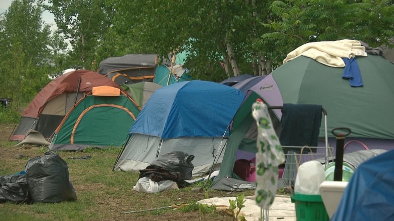 A tent city is shown during the summertime in Canada.