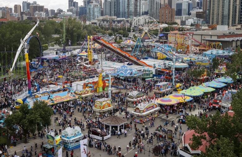 The midway grounds are seen with the Calgary skyline at the back. 