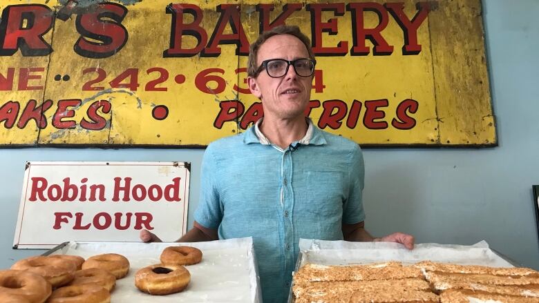 Keith Jorgenson stands with donuts at his bakery