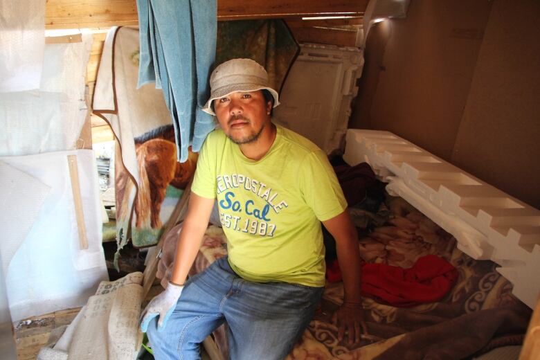 A man sits in a shelter.