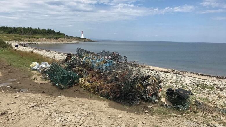 Abandoned lobster traps and other fishing gear piled on the shore near New Victoria.