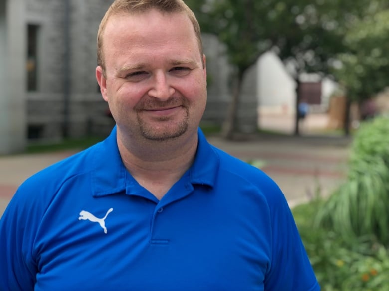 A man with a blue shirt.