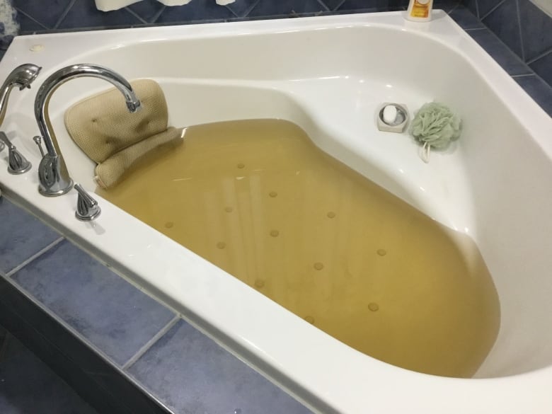 Brown water in a bathtub.